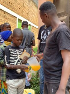 Kids participating in a community art project with the Speaking Wall behind them